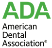 The image is a logo that reads 'ADA' at the top, followed by a stylized graphic of a hand with a finger extended upwards. Below this symbol are two lines of text: 'AMERICAN DENTAL ASSOCIATION' on the upper line and 'DESIGNS IN DENTISTRY ASSOCIATION' on the lower line. The logo is set against a white background, and the colors used for the text and graphic are primarily in shades of green and black.
