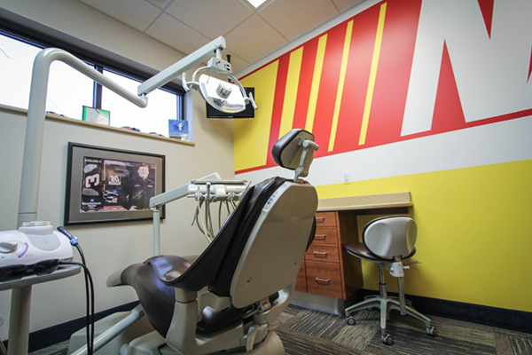 An interior view of a dental office, featuring dental chairs and equipment.