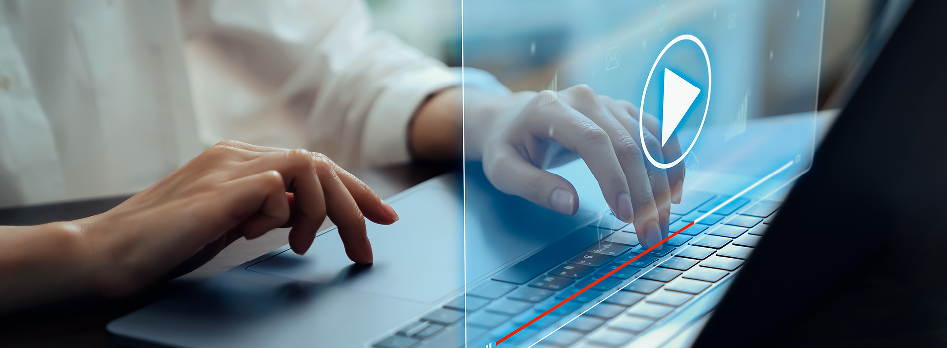 The image shows a person s hands typing on a laptop keyboard, with a blurred background that suggests an office environment.