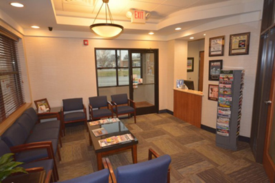 Waiting area within a medical office, featuring a reception desk and seating for patients.