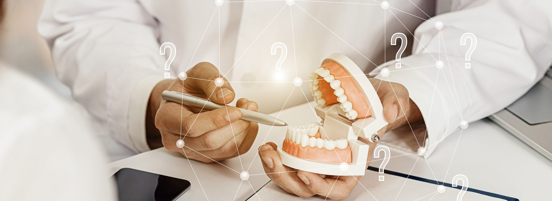 A dental professional examining a set of teeth with an open mouth model, surrounded by digital information and symbols.