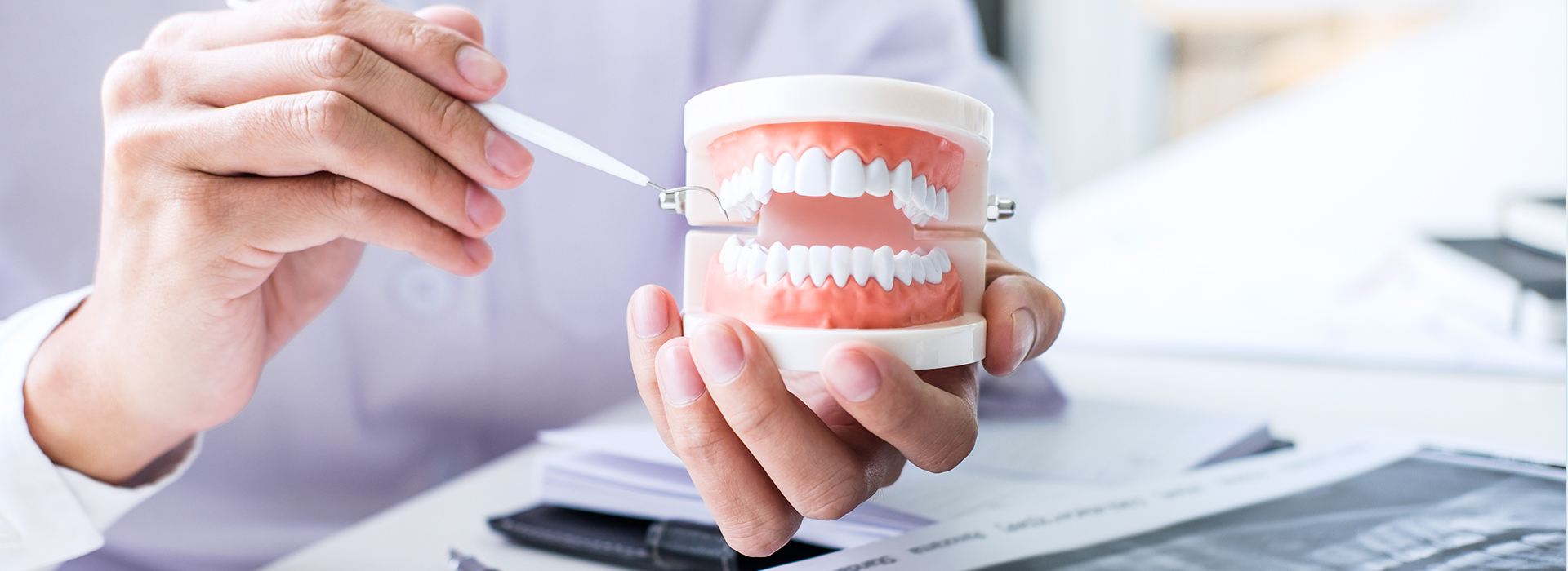 The image shows a person s hand holding a toothbrush with toothpaste, positioned in front of a cup of coffee.